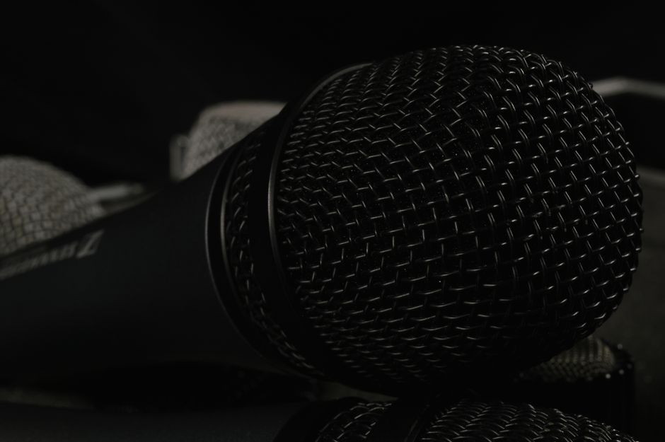 A detailed close-up of professional microphones featuring windscreens, ideal for tech and audio themes.